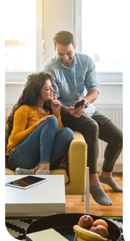 Couple looking at their mobile phone