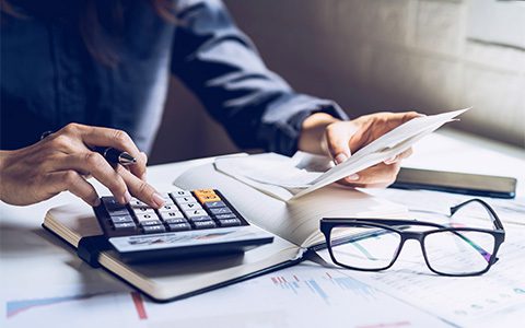 Financial hardship Person using a calculator